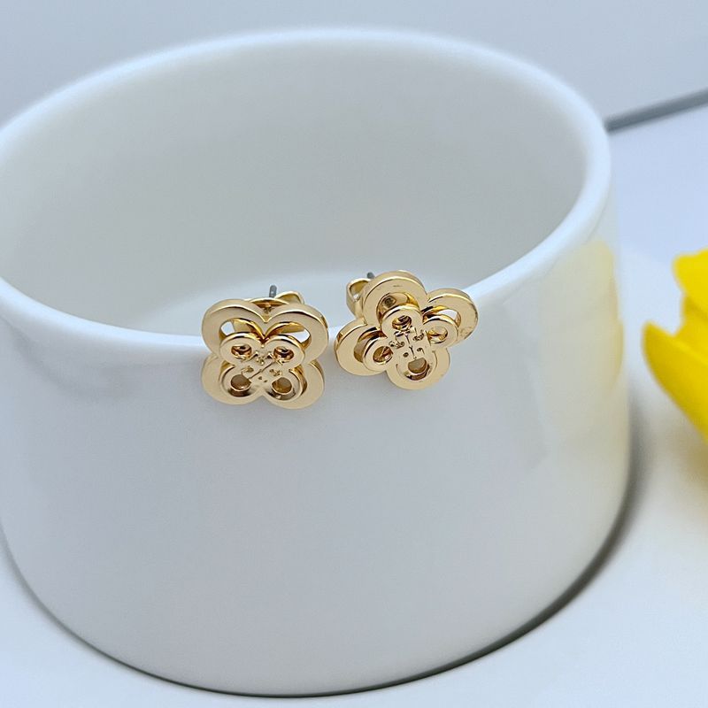Clean, front-facing macro shot of a single earring against a soft, blurred botanical background or neutral tone, showcasing the intricate cluster of flowers and leaves.