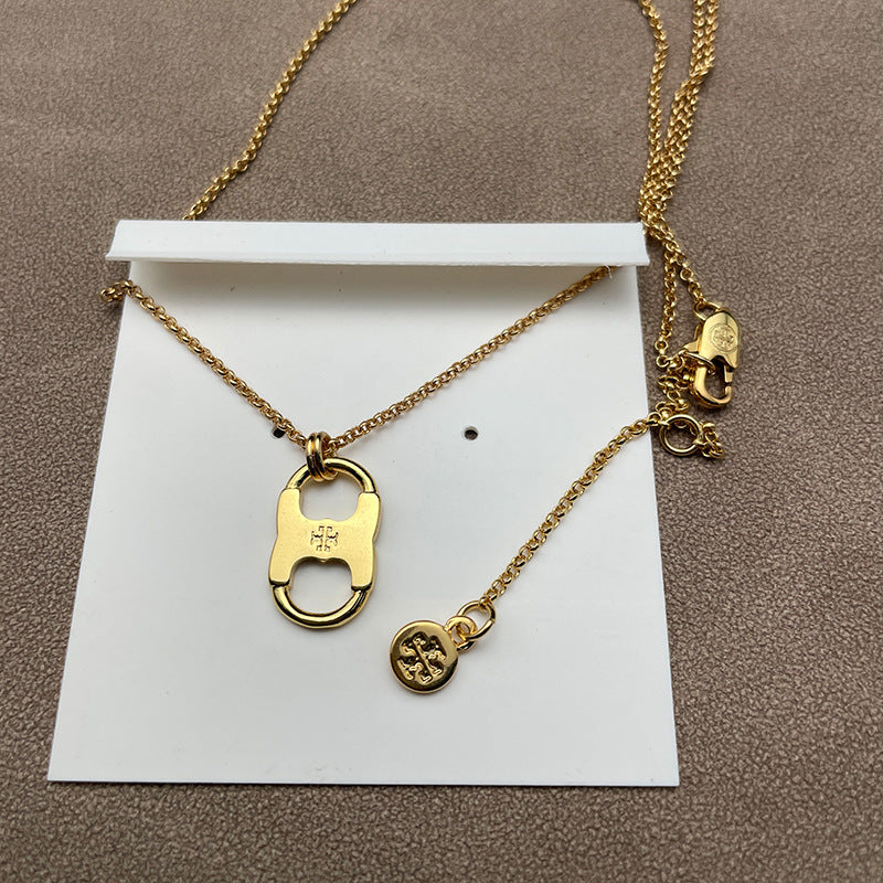 Necklace laid flat on a soft, starry-inspired or solid light background, highlighting the petite pendant and delicate chain.