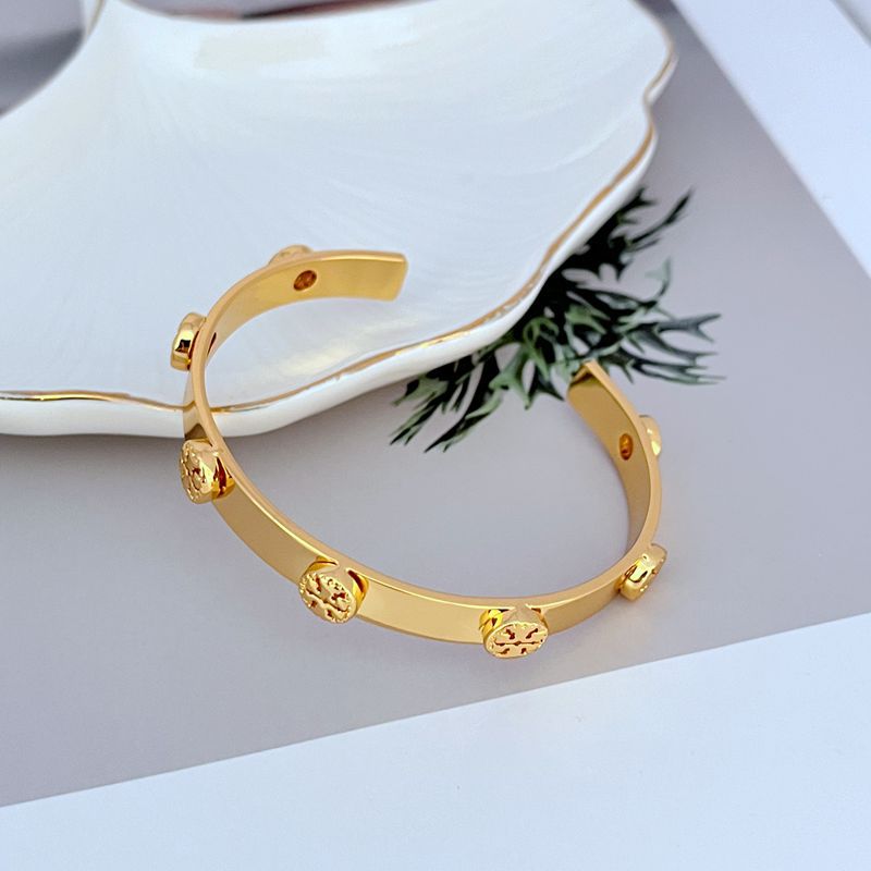 Extreme close-up of the Double T logo, focusing on its finish and detailing.