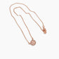 A delicate rose gold chain necklace featuring a circular pendant with a raised 'T' monogram and a small matching charm, displayed on a clean white background.