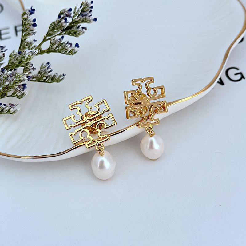 Clean, vertical shot of a single earring against a soft background, clearly showing the Double T emblem above the dangling pearl(s).