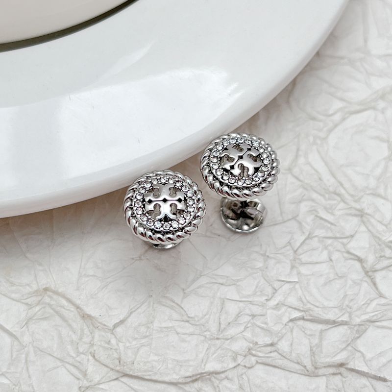 Clean product grid with “Sale” badges, showing original and sale prices strikethrough. Include variety: studs, hoops, drops.