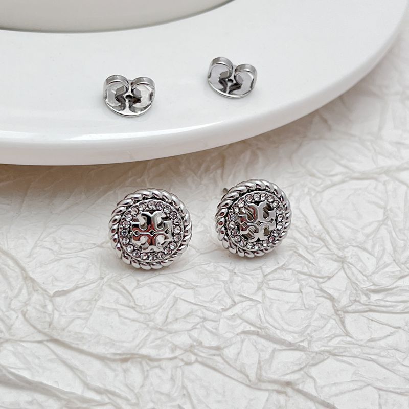 Clean product grid with “Sale” badges, showing original and sale prices strikethrough. Include variety: studs, hoops, drops.