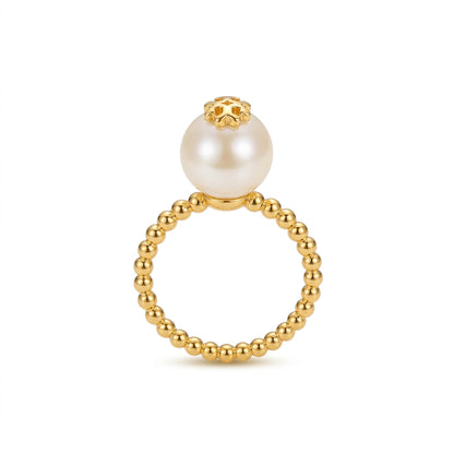 A gold beaded ring featuring a large white pearl suspended at the top, set against a clean white background.