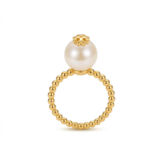 A gold beaded ring featuring a large white pearl suspended at the top, set against a clean white background.