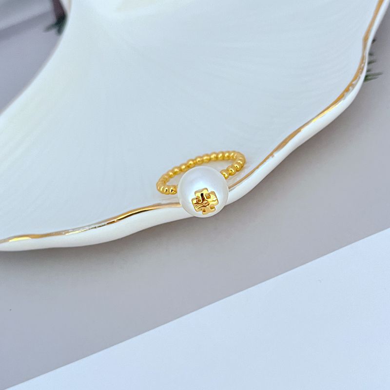 Clean shot of the ring on a neutral background, highlighting the textured milgrain, rope detail, and central pearl.