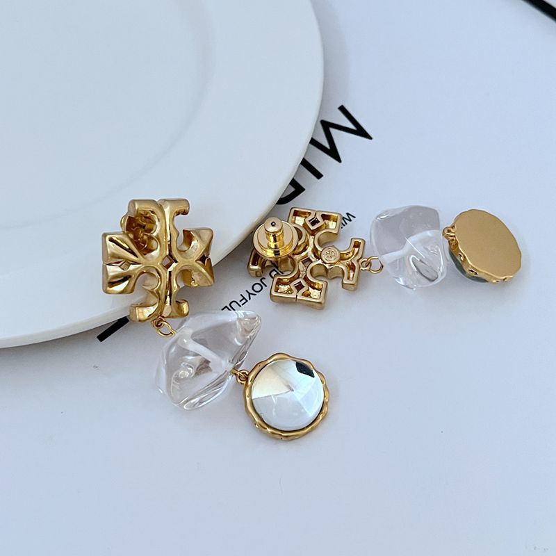  Clean, vertical shot of a single earring against a contrasting dark background, highlighting the textured detail and warm yellow gold tone of the rolled brass.