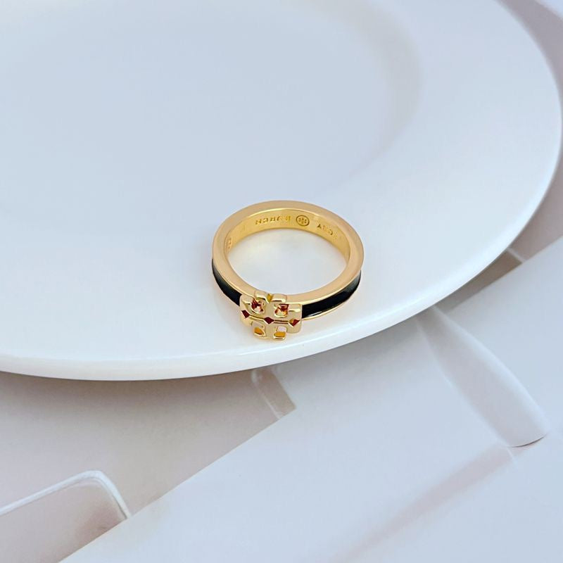  Clean, bright shot of the ring on a neutral background, making the colored enamel and gold logo the clear focal point.