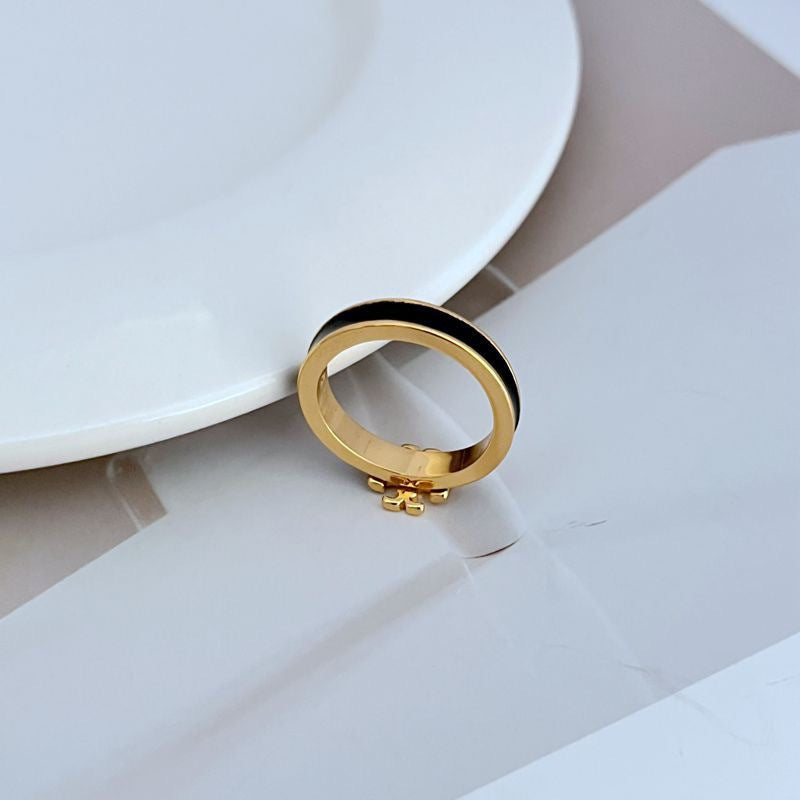  Clean, bright shot of the ring on a neutral background, making the colored enamel and gold logo the clear focal point.