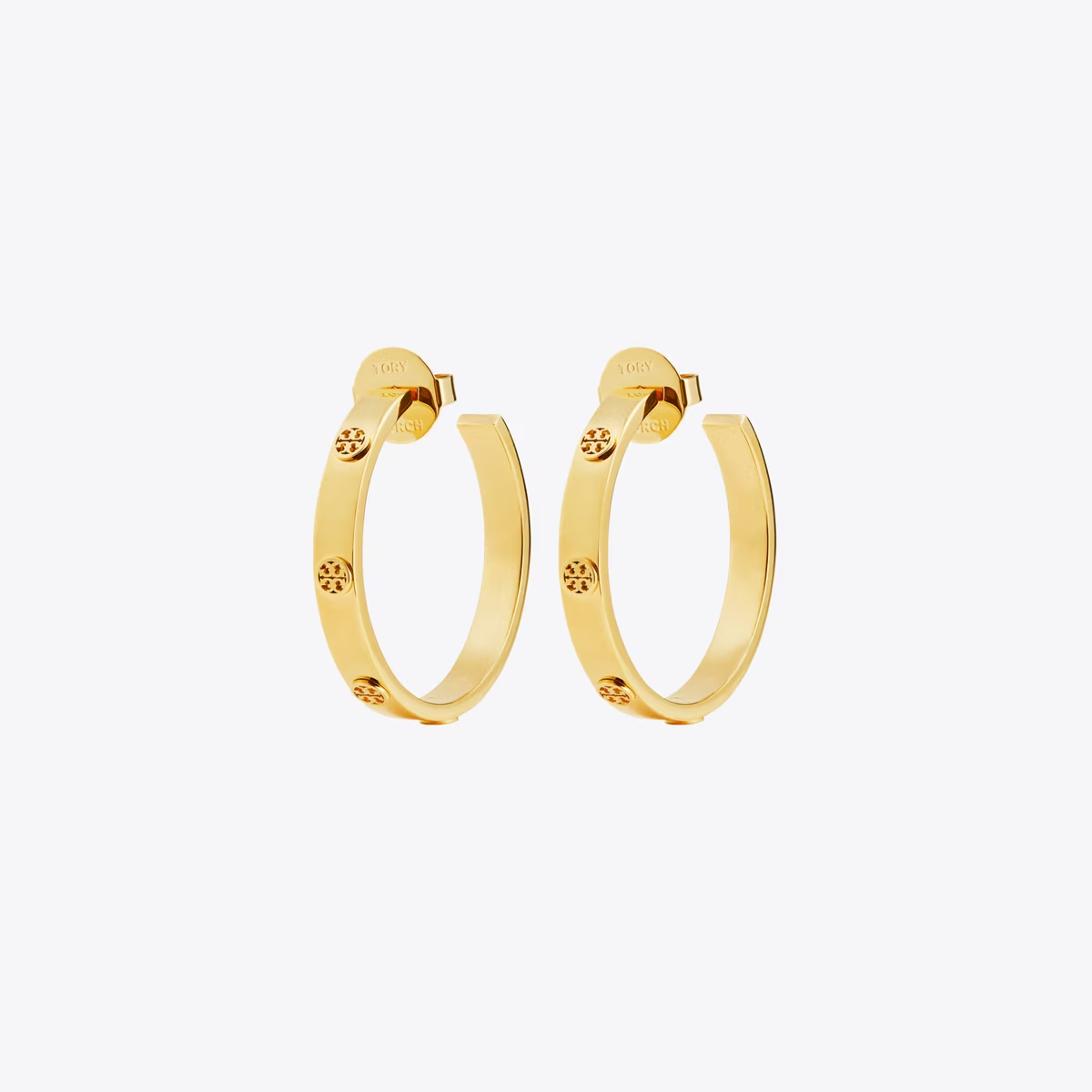 A pair of gold hoop earrings with small star-shaped crystal accents, displayed on a clean, light gray background.