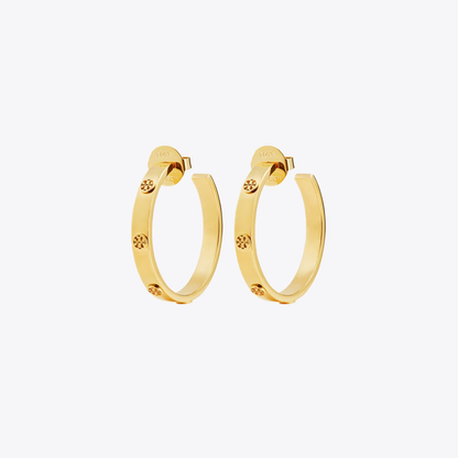 A pair of gold hoop earrings with small star-shaped crystal accents, displayed on a clean, light gray background.