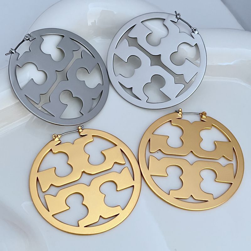 Macro shot tightly focused on the Double T logo detail, highlighting its precise engraving and polished finish within the hoop.