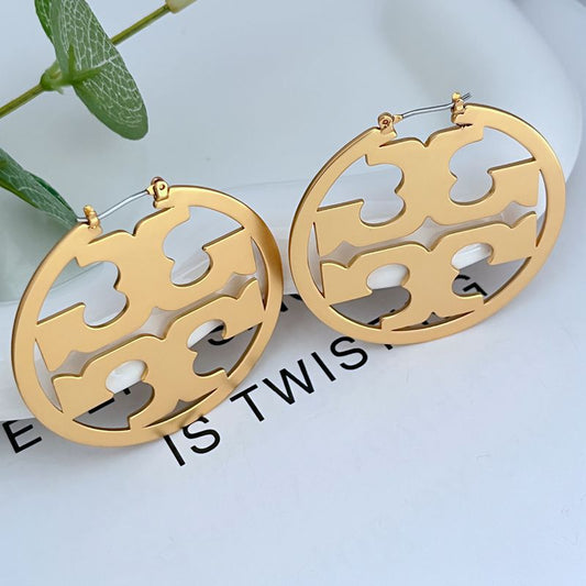 Clean, front-facing shot of a single hoop against a neutral background, clearly showcasing the Double T logo integrated into the hoop's curve.