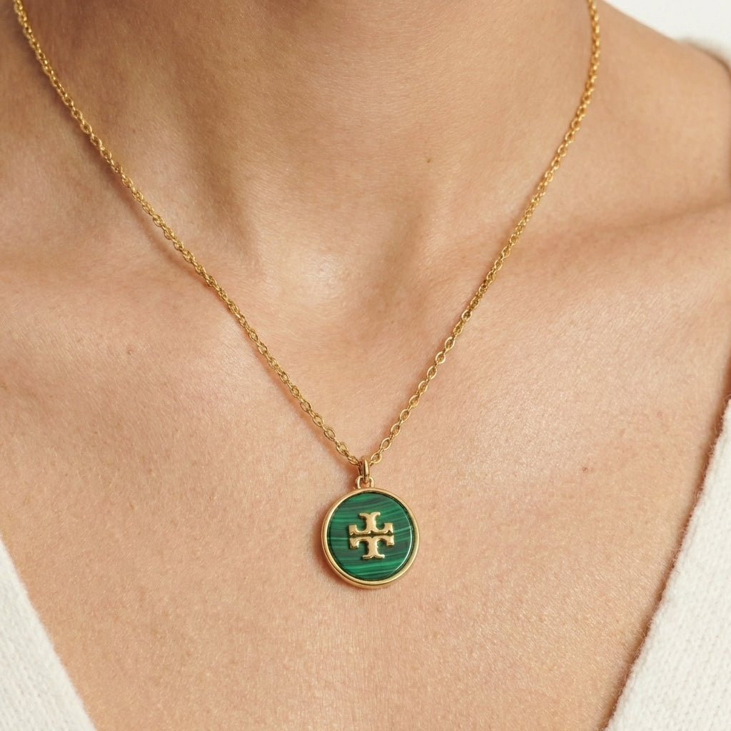 Close-up of collarbone with pendant precisely centered. Chain acts as a guiding line toward the pendant. Clean background, soft lighting, strong single focal point.
