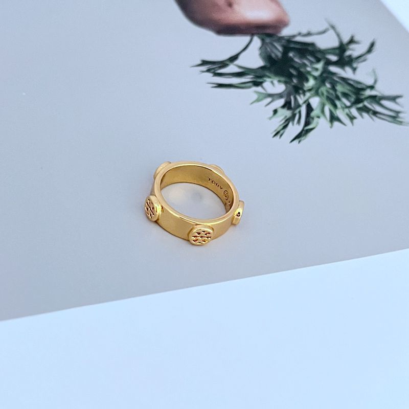 Macro shot focused on the engraved details and smooth finish of the Double T emblem.