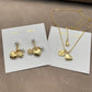 Both earrings displayed hanging naturally against a light background, showing all charms clearly arranged in sequence.