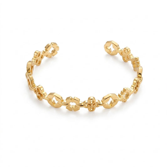 A gold open cuff bracelet with a repeating geometric link pattern, shown on a clean white background.