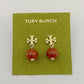 Tory Burch earrings with gold designs and red beads on a green card.