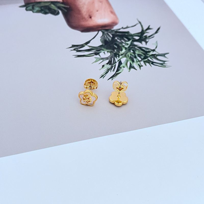 Clean, front-facing macro shot of a single Tory Burch Kira Enamel Flower Stud, showcasing the detailed petal design and vibrant enamel color against a soft, neutral background.