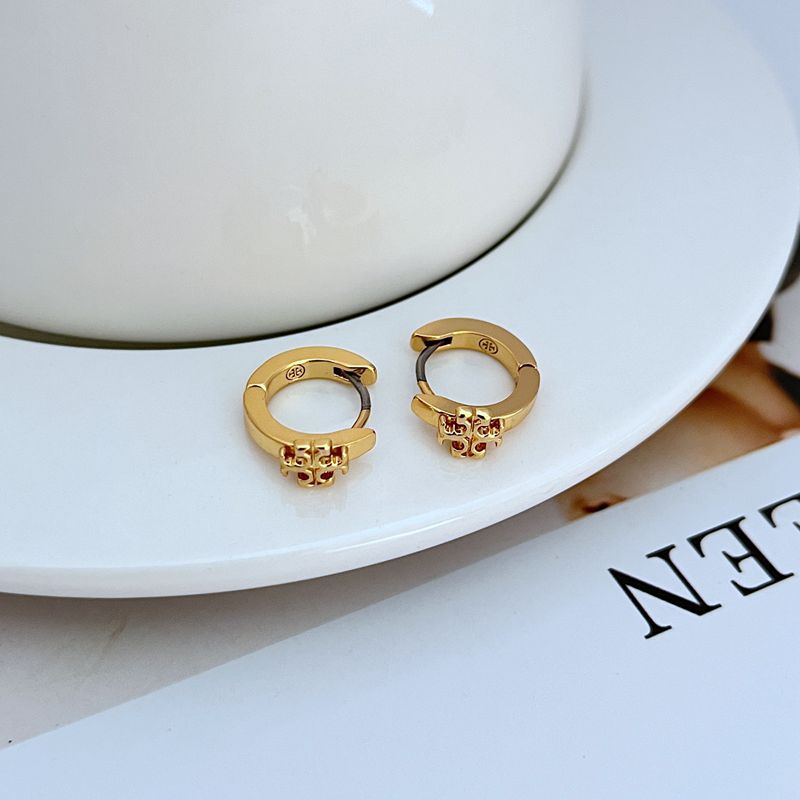 Tory Burch-inspired Kira Enamel Huggie Earrings in [Color Name] displayed on a soft-toned background, highlighting the curved gold hoop and vibrant enamel band."