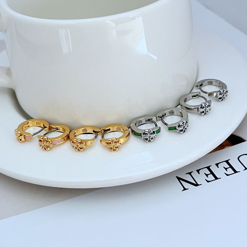 Tory Burch-inspired Kira Enamel Huggie Earrings in [Color Name] displayed on a soft-toned background, highlighting the curved gold hoop and vibrant enamel band."