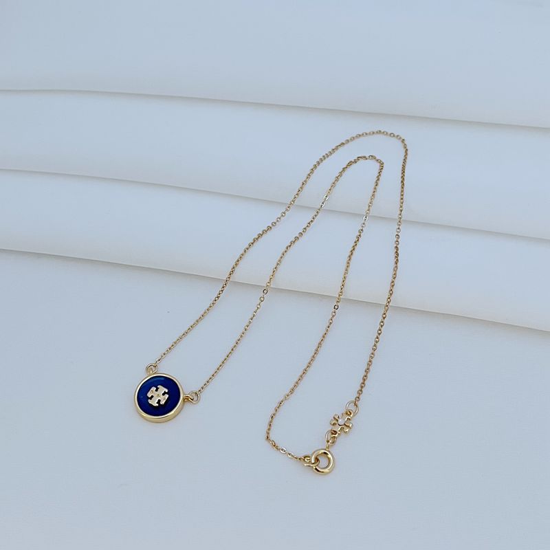 The necklace laid flat on a clean white or light gray background, making the enamel colors and gold-tone frame stand out vividly.