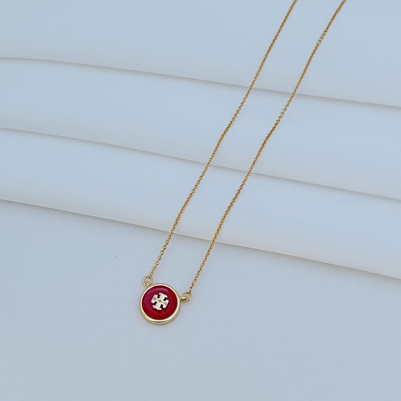 The necklace laid flat on a clean white or light gray background, making the enamel colors and gold-tone frame stand out vividly.