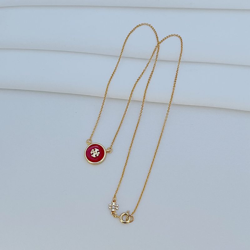 The necklace laid flat on a clean white or light gray background, making the enamel colors and gold-tone frame stand out vividly.