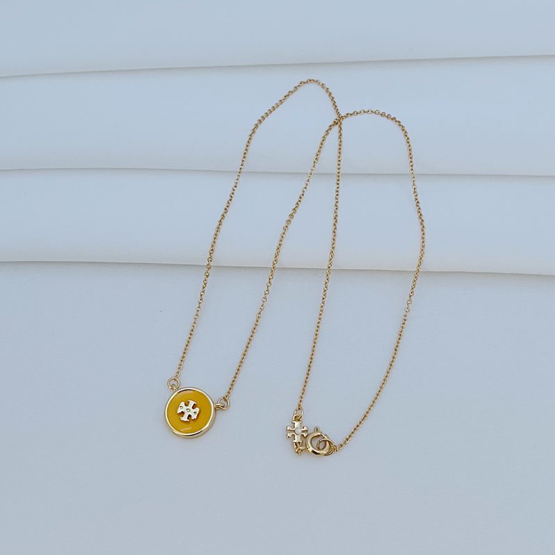 The necklace worn with a neutral-toned outfit (white tee, denim shirt), allowing the colorful pendant to become the focal point.