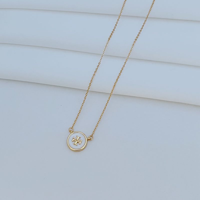 The necklace worn with a neutral-toned outfit (white tee, denim shirt), allowing the colorful pendant to become the focal point.