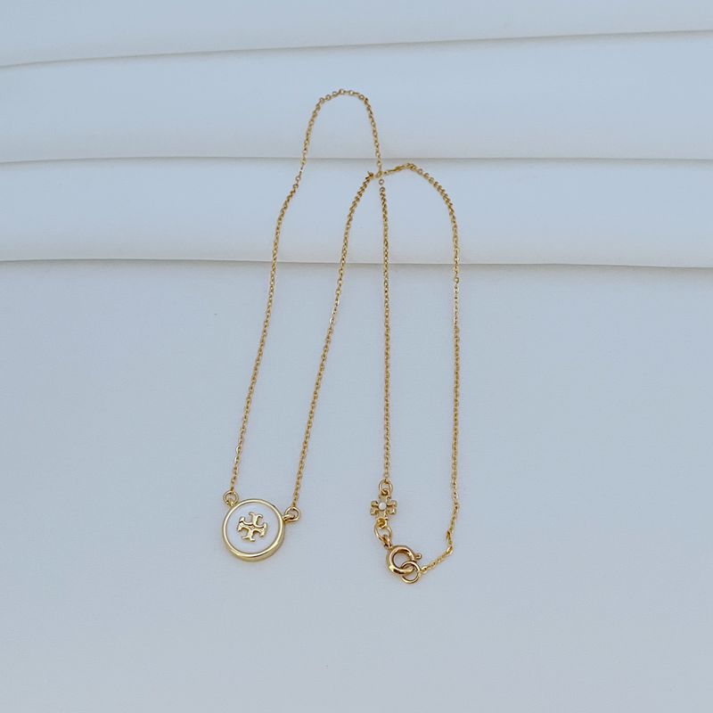 The necklace worn with a neutral-toned outfit (white tee, denim shirt), allowing the colorful pendant to become the focal point.