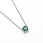 A silver-tone chain necklace with a four-petal flower pendant featuring a vibrant green enamel center and a silver-tone monogram logo.