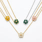 Five floral clover pendant necklaces on layered chains, shown on a clean white background. The necklaces feature gold, silver, yellow, green, and pink pendants, each with a small central star detail.