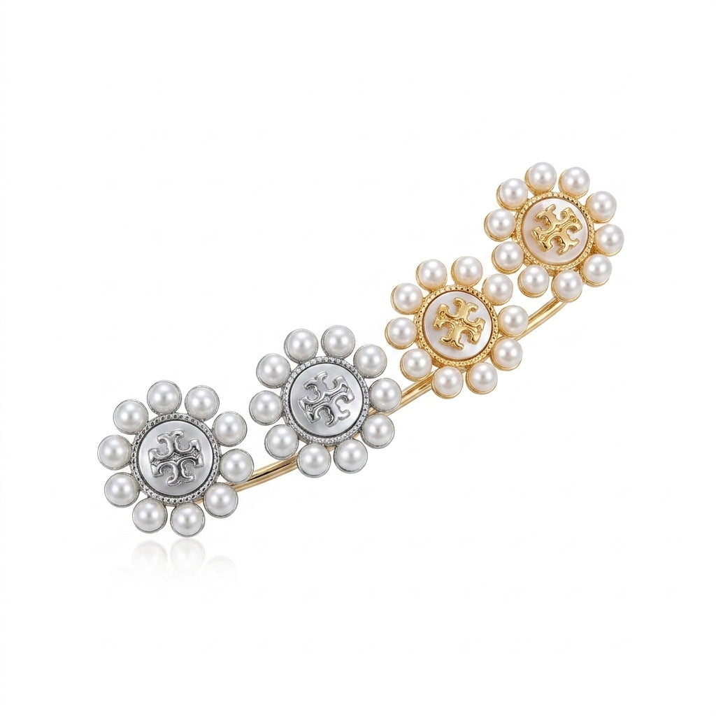 Pair of pearl earrings with floral designs on a white background