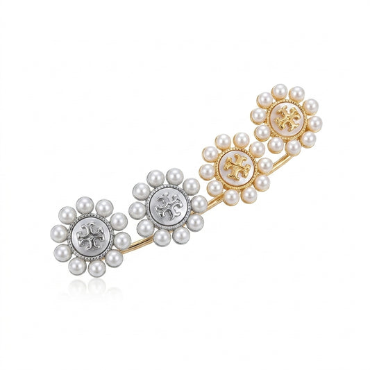 Pair of pearl earrings with floral designs on a white background