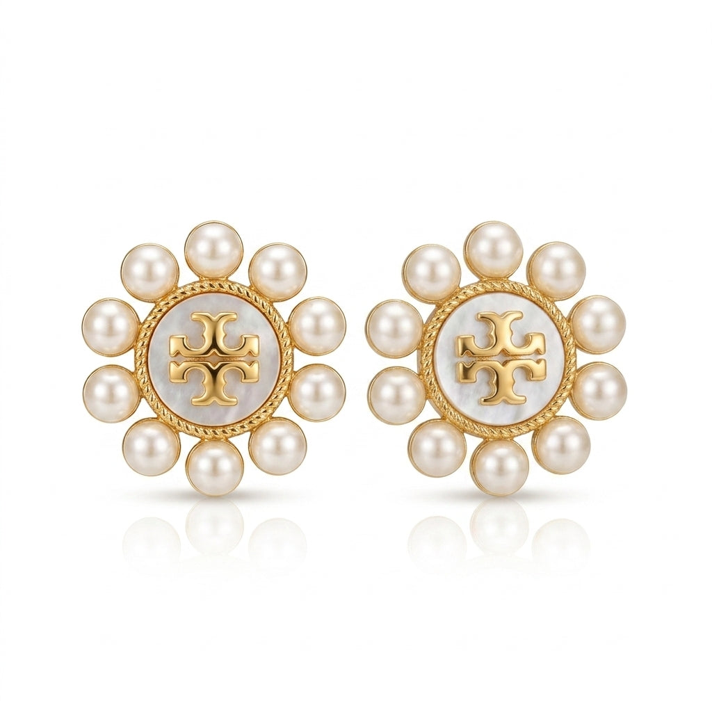 Pair of pearl earrings with a gold logo on a white background