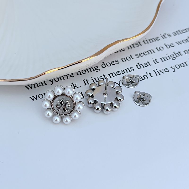 Close-up focusing on the chevron-inspired petals and the smooth pearl at the center.