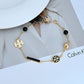 Close-up focusing on a cluster of chevron beads and a charm, showcasing their detailed texture and finish.