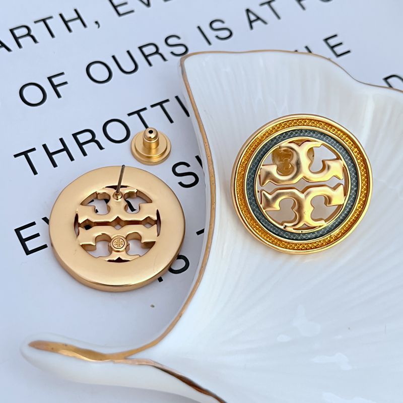 Macro shot focusing on the precise edges and polished surface of the large round disc and the iconic Double T engraving.