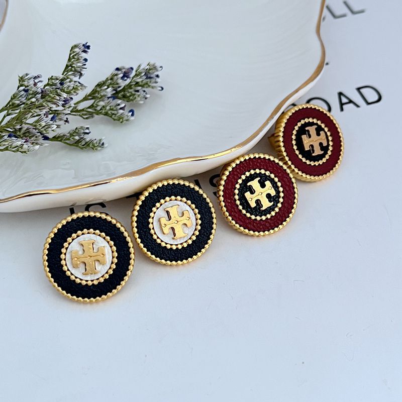  Extreme macro shot focused on the leather inlay, showcasing its grain, color depth, and the precise setting within the metal frame.

