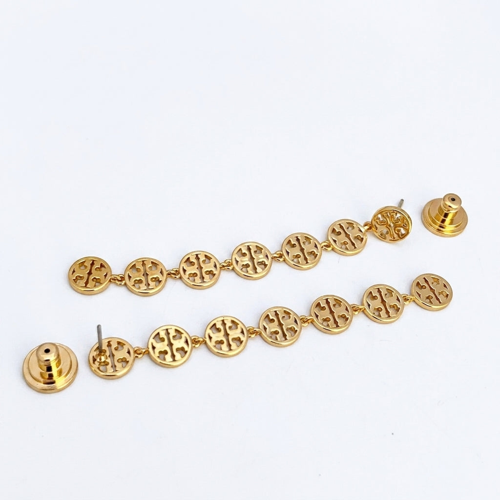 A pair of gold-toned dangle earrings with circular links featuring an interlocking cross design, shown with their silver-tone post and backing on a plain white background.