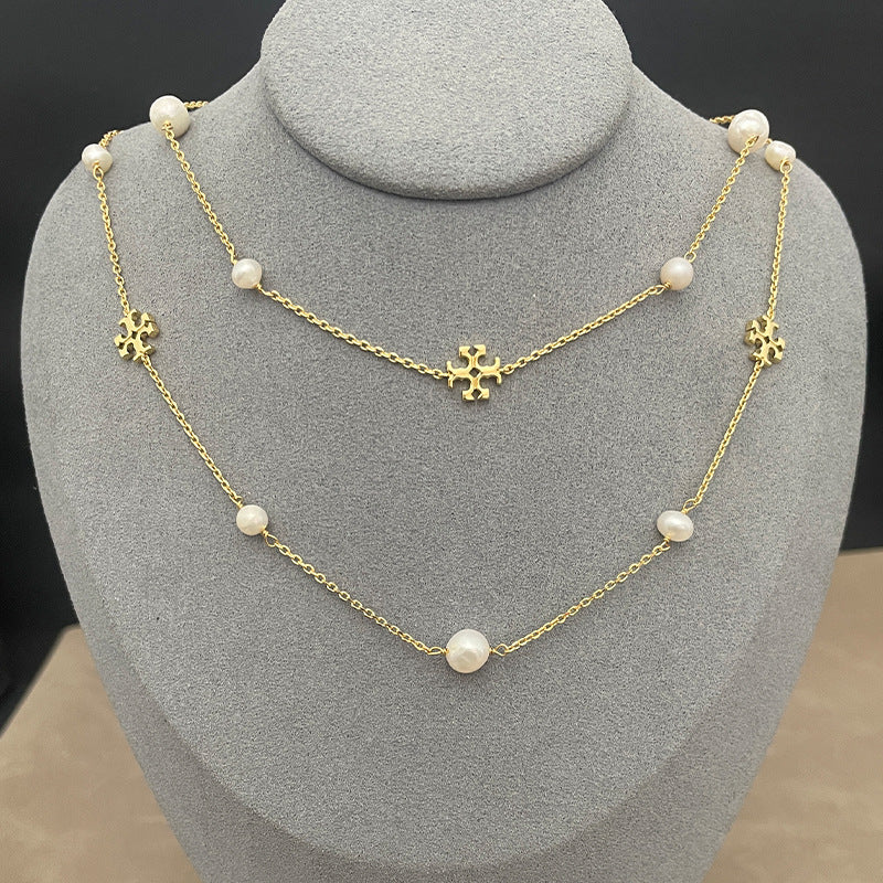 The necklace worn with a simple top or dress, showing how it falls at collarbone-to-chest length and layers elegantly.