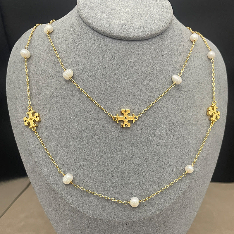 The necklace worn with a simple top or dress, showing how it falls at collarbone-to-chest length and layers elegantly.