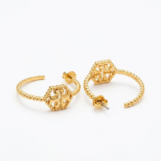 A pair of gold-toned hoop earrings with textured beaded bands and geometric filigree front charms, displayed on a clean white background.