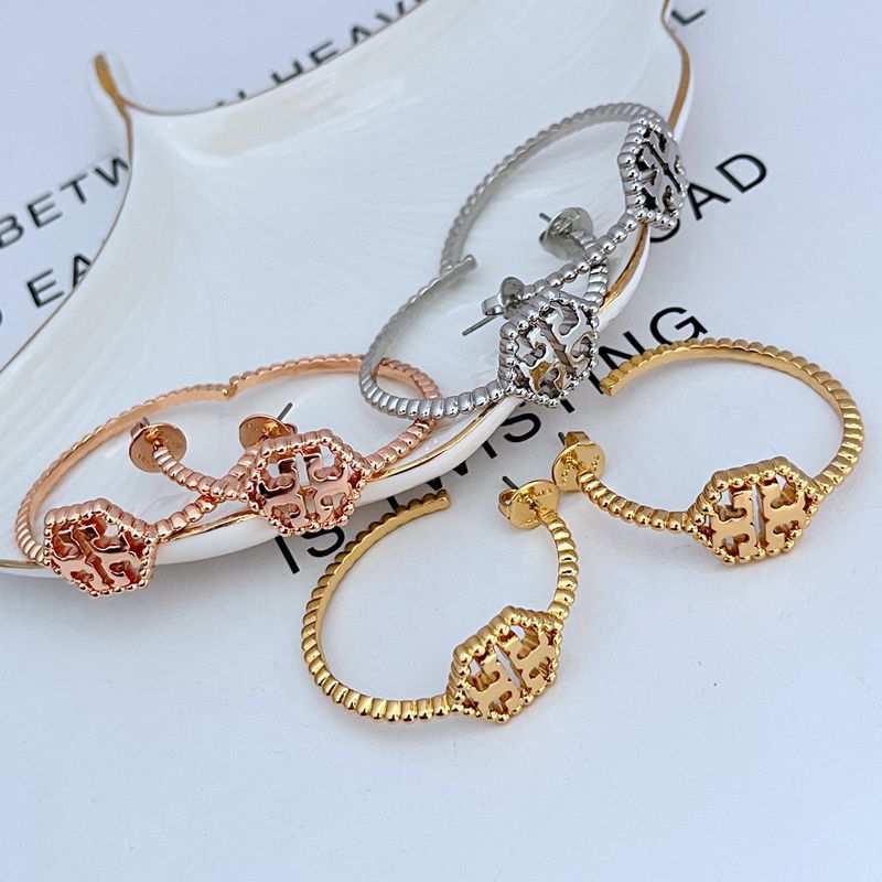 Both hoops displayed flat or slightly angled on a neutral background, highlighting the hexagonal shape, rolled edge, and milgrain beading.