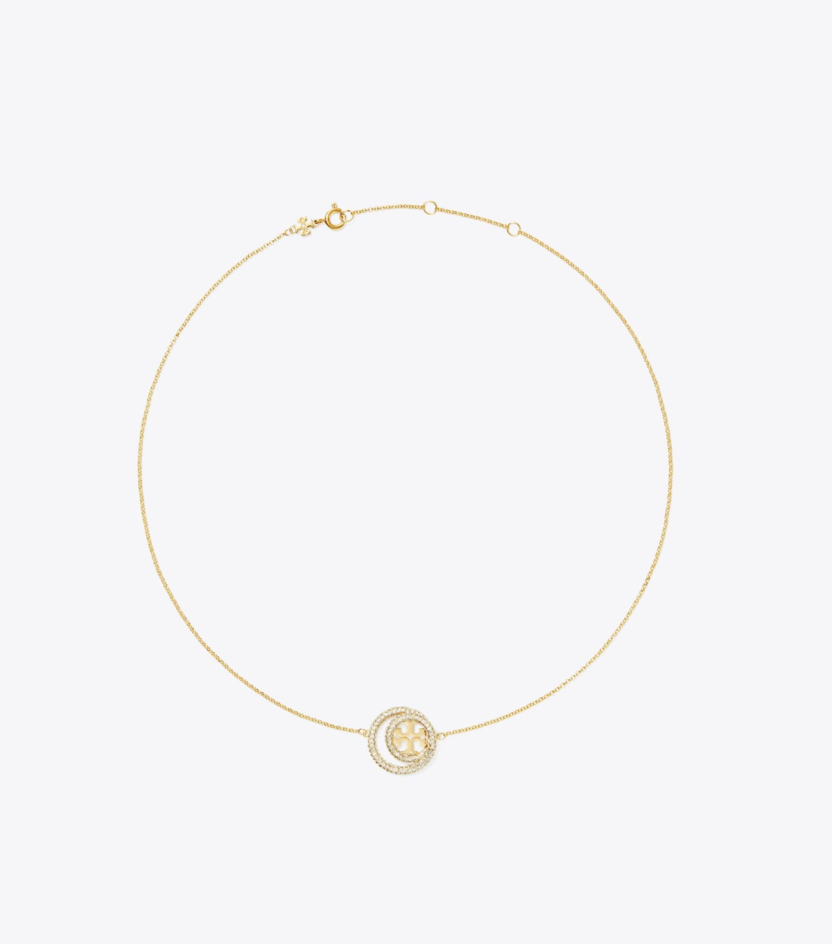 A delicate gold chain bracelet with a circular double-ring pendant featuring a central floral motif, displayed on a clean white background.