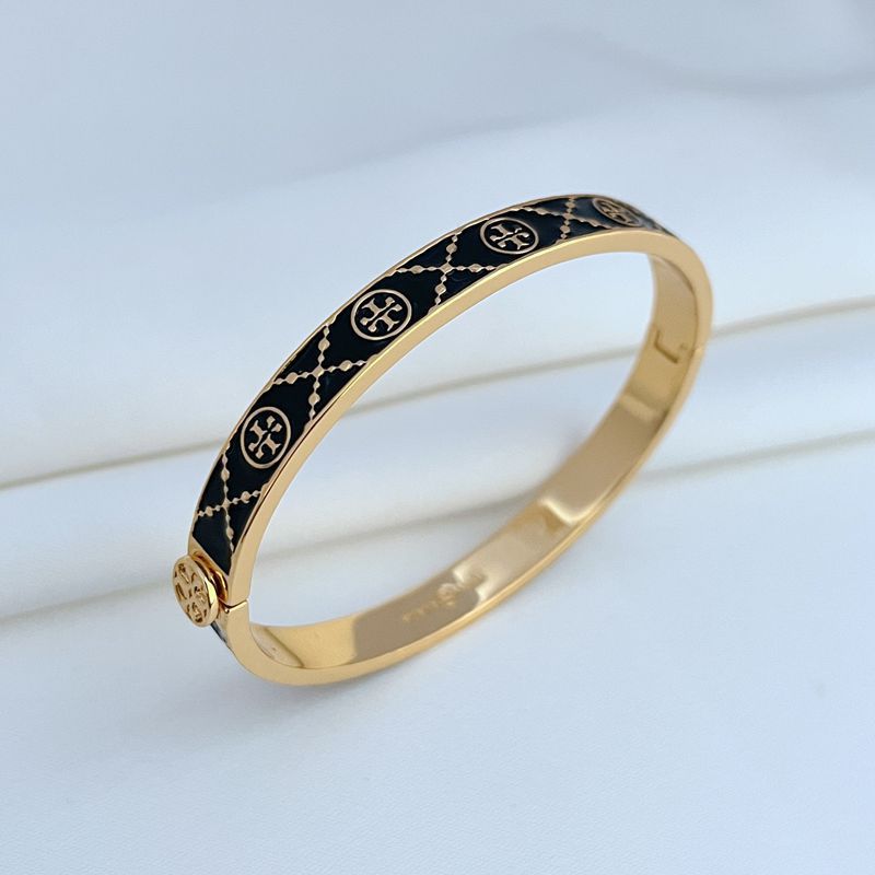 Bracelet displayed open or slightly curved on a solid dark background, emphasizing the enamel logo and smooth cuff shape.