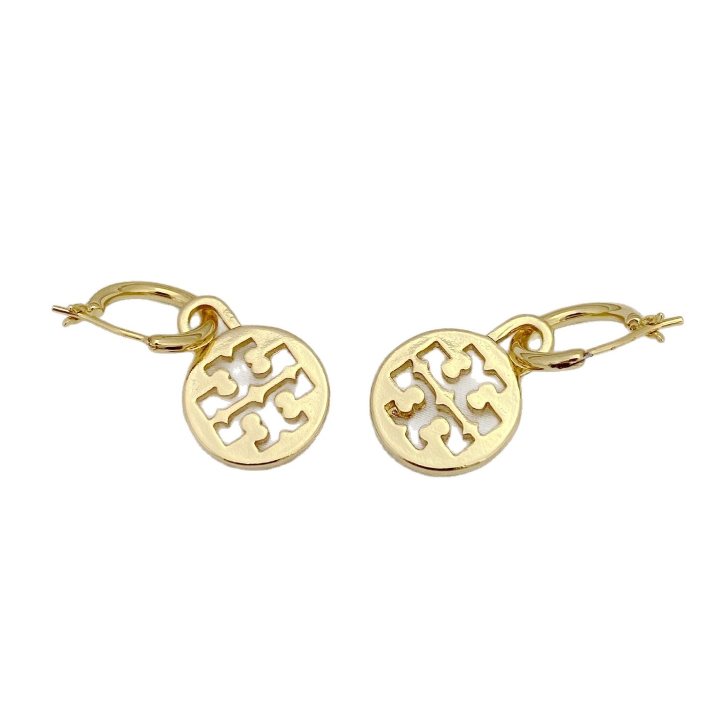 Gold earrings with a cut-out design on a white background