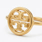 A gold-tone ring featuring a circular openwork design with a stylized interlocking monogram logo, photographed on a clean white background.