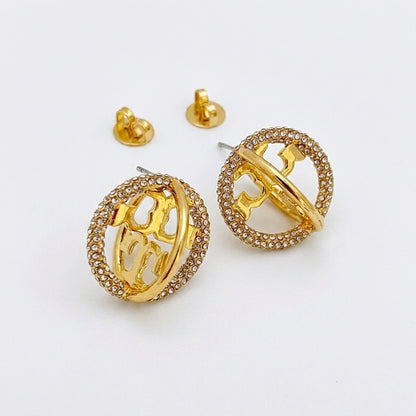 Gold hoop earrings with intricate designs on a white background
